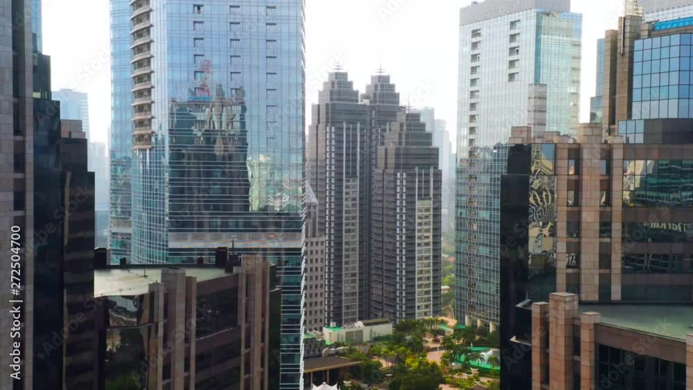 JAKARTA, Indonesia - May 27, 2019: Aerial view of central business district and modern skyscrapers with glass windows. Shot in 4k resolution from a drone flying forwards JAKARTA, Indonesia - May 27, 2019: Aerial view of central business district and modern skyscrapers with glass windows. Shot in 4k resolution from a drone flying forwards