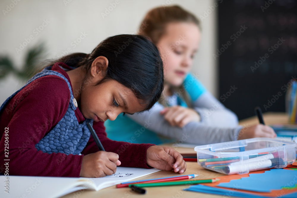 Artistic young indian girl drawing in art class Artistic young indian girl drawing in art class