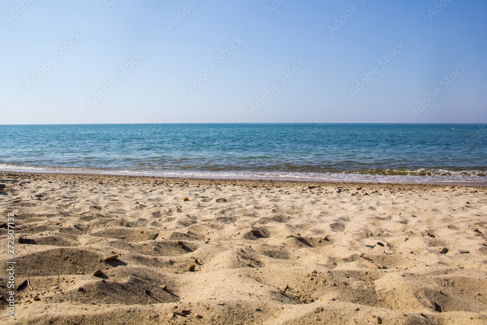 Seascape of sand shore and waves of Black sea
