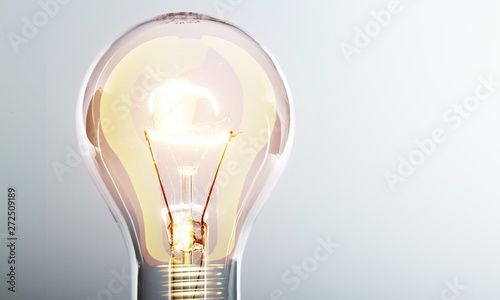 Glowing yellow light bulb, busienss idea concept