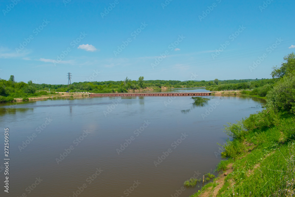 A river with a pontoon bridge. Russian nature