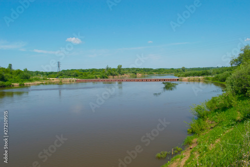 A river with a pontoon bridge. Russian nature