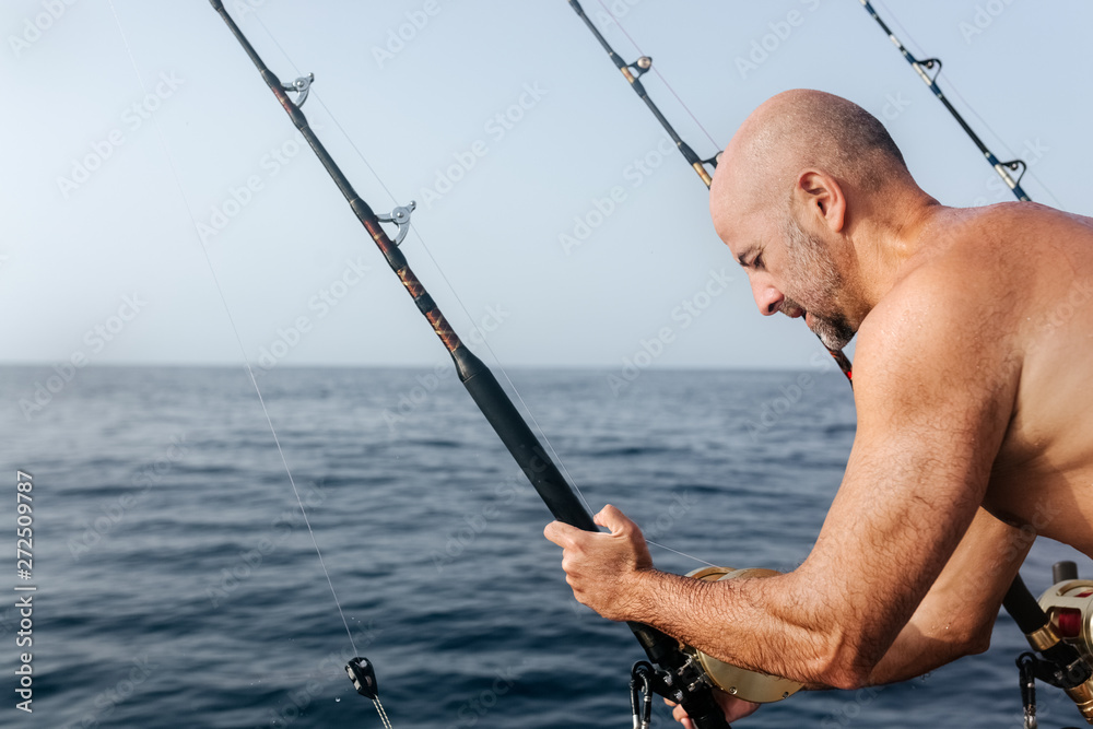 Man working on a fishing boat Man working on a fishing boat