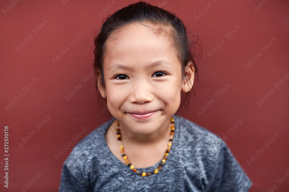 Pretty Asian little girl expression. Ancient architecture wall background Pretty Asian little girl expression. Ancient architecture wall background