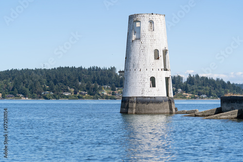 Abandoned lighthouse in the Puget Sound of Washington in the Pacific Northwest once used as a shipping port photo