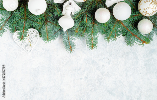 Christmas composition. Christmas gift, knitted blanket, pine cones, fir branches on wooden white background. Flat lay, top view, copy space