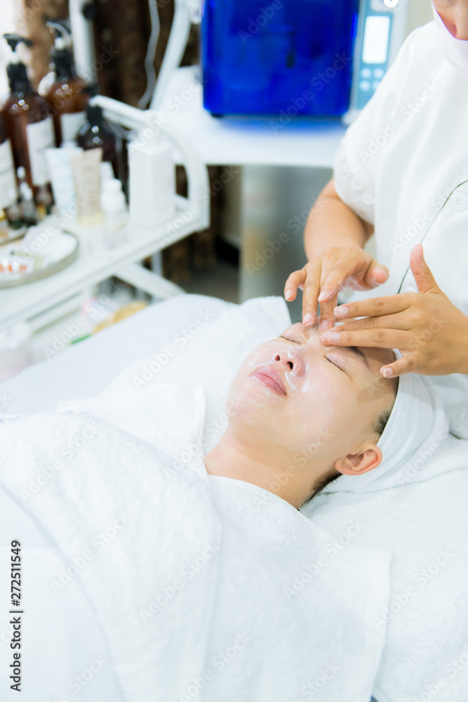 Woman receiving face and scalp massage Woman receiving face and scalp massage