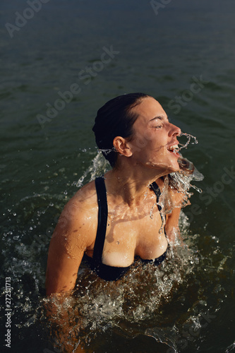 Female comes up from water. photo