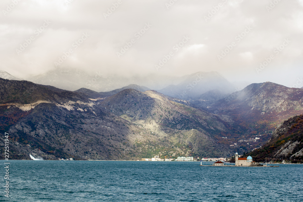 Boko-Kotor Bay, view of the Our Lady of the Rocks island in winter, partial focus