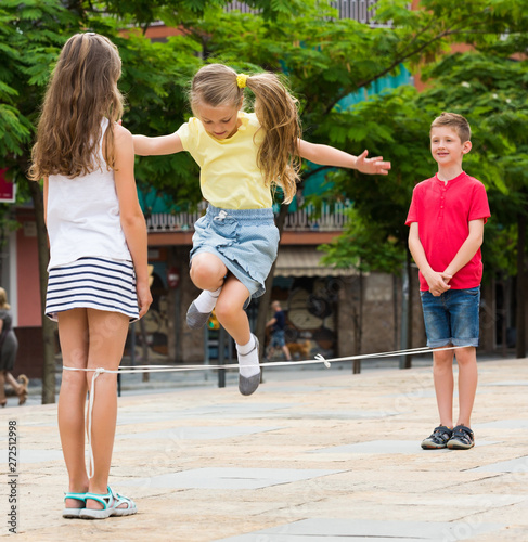 Kids hop on elastic jumping rope