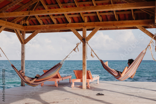 Couple Relaxing in Hammocks by Ocean