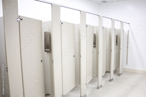 Several toilet stalls in a public restroom photo