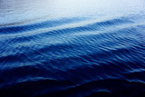 Diagonal waves on the surface of the sea. Big dimension blue background