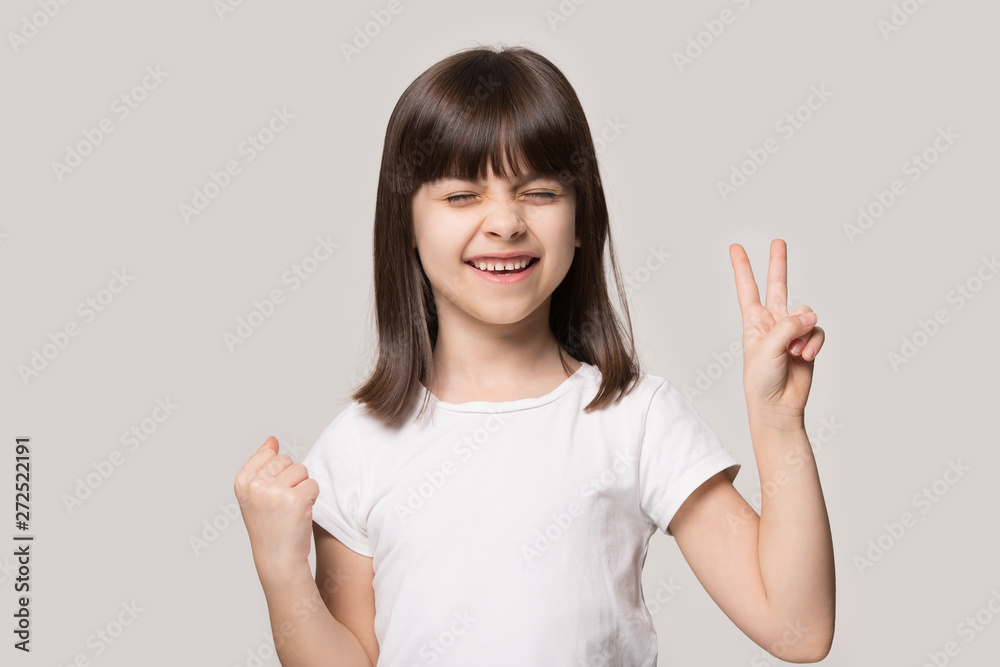 Little girl got what she wanted showing victory gesture symbol Little girl got what she wanted showing victory gesture symbol