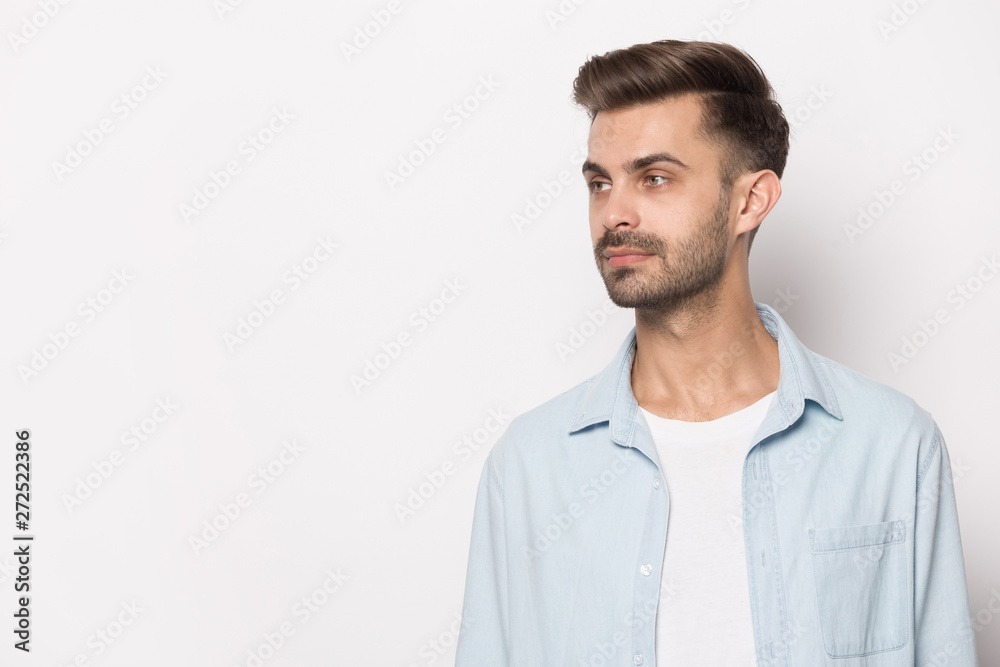 Handsome guy looking aside at copy space white studio background Handsome guy looking aside at copy space white studio background