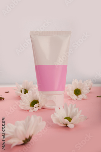 Natural organic cosmetic packaging mock up with leaves and flowers. Mock-up bottle for branding and label