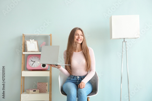 Smiling young woman holding...