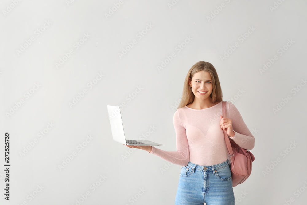 Female student with laptop on light background Female student with laptop on light background