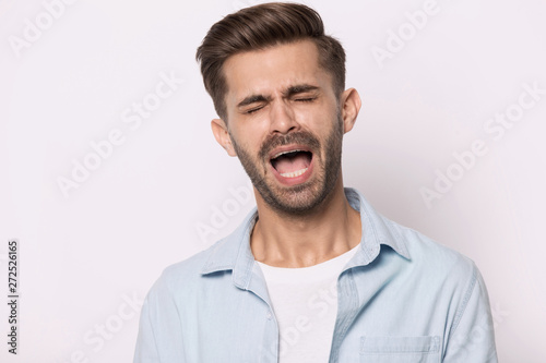 Hysterical guy closed eyes screaming or whines isolated on white