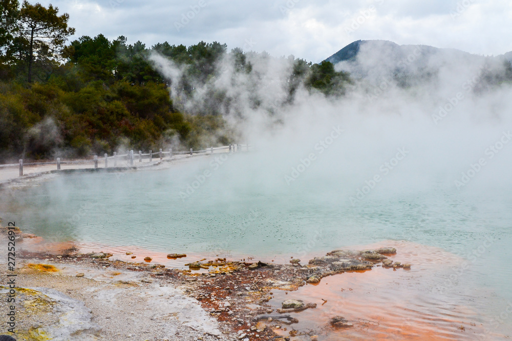 View of colorful steaming volcanic Champagne pool in geothermal Wai-O-Tapu wonderland in Rotorua, North Island, New Zealand. Tourist popular unique natural attraction. View of colorful steaming volcanic Champagne pool in geothermal Wai-O-Tapu wonderland in Rotorua, North Island, New Zealand. Tourist popular unique natural attraction.