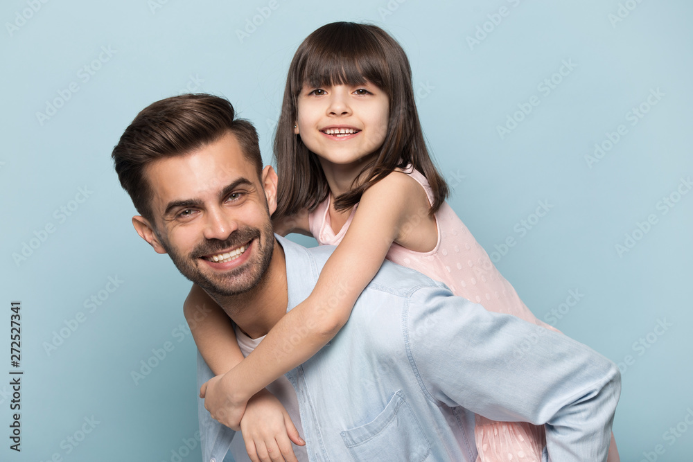 Father holding on back adorable preschool kid studio shot Father holding on back adorable preschool kid studio shot