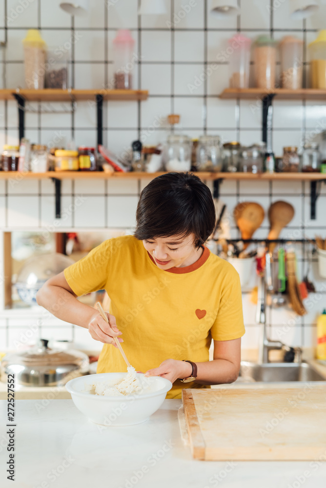 Young woman cooking in kitchen Young woman cooking in kitchen