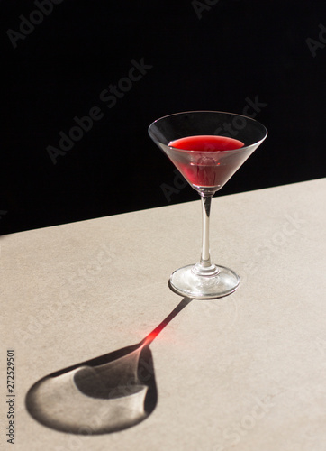 Direct view of red alcohol in cocktail glass kept on table