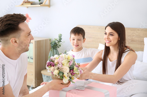 Family greeting young woman...