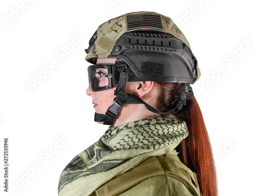 Portrait of fully equipped young military soldier woman with red hair in helmet, side view, isolated photo. © syberianmoon