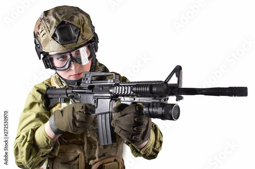 Beautiful fully equipped military soldier woman aiming at the enemy with automatic rifle M16, isolated photo.