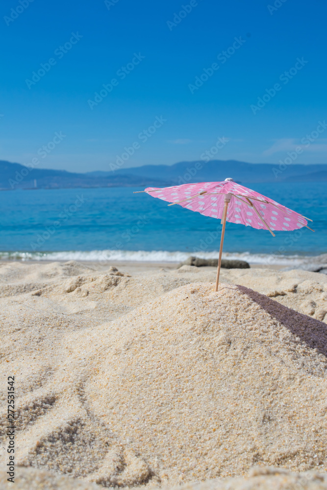 parasol in the sand of the beach, summer and holidays