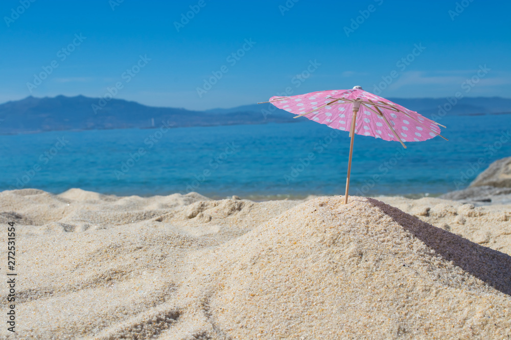 parasol in the sand of the beach, summer and holidays