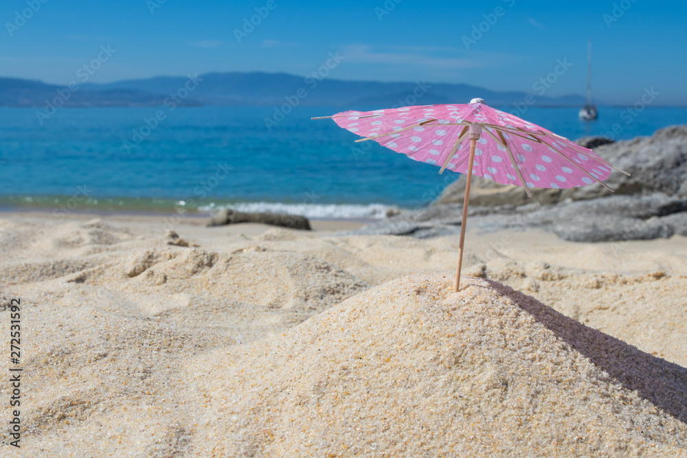 parasol in the sand of the beach, summer and holidays parasol in the sand of the beach, summer and holidays