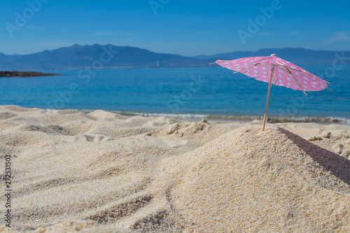 parasol in the sand of the beach  summer and holidays