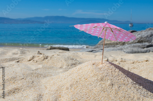 parasol in the sand of the beach, summer and holidays