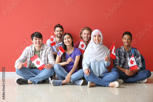 Photography Group of students with Canadian flags sitting near color wall