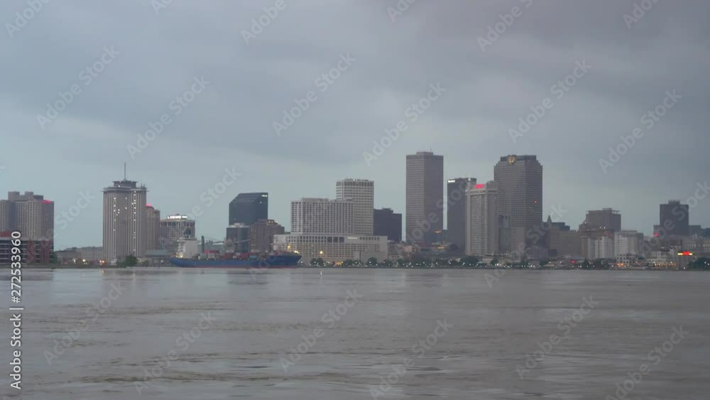 Beautiful landscape of New Orleans skyline on a cloudy day and a ship going to port. USA. Flat plane Beautiful landscape of New Orleans skyline on a cloudy day and a ship going to port. USA. Flat plane