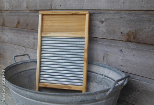 Wood and galvanized metal washboard in galvanized wash tub