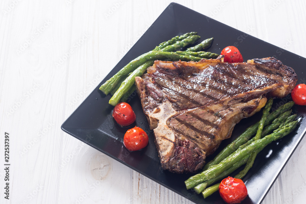 Grilled T-bone steak with asparagus and cherry tomatoes Grilled T-bone steak with asparagus and cherry tomatoes