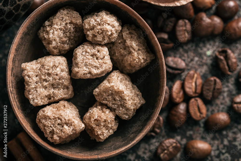 Sugar with coffee beans on dark textured background. Sugar with coffee beans on dark textured background.