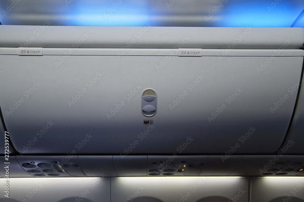Moden commercial aircraft overhead locker, seat number. Moden commercial aircraft overhead locker, seat number.
