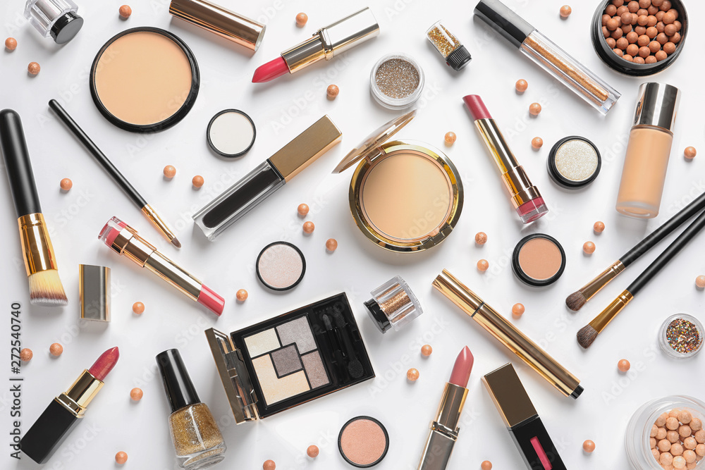 Different luxury makeup products on white background, top view Different luxury makeup products on white background, top view