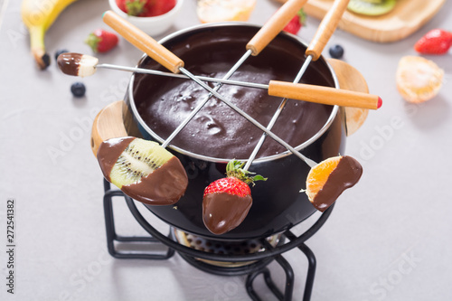 Chocolate fondue whith fruit and berries photo