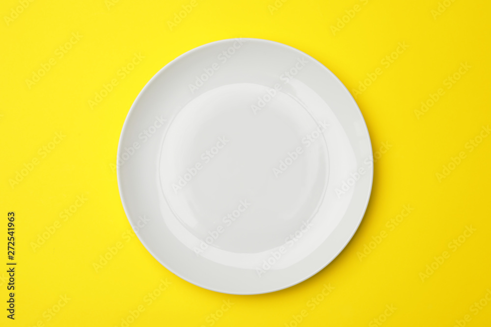 Clean empty plate on color background, top view Clean empty plate on color background, top view