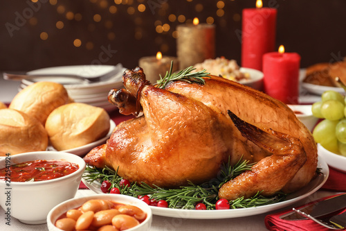 Traditional festive dinner with delicious roasted turkey served on table photo