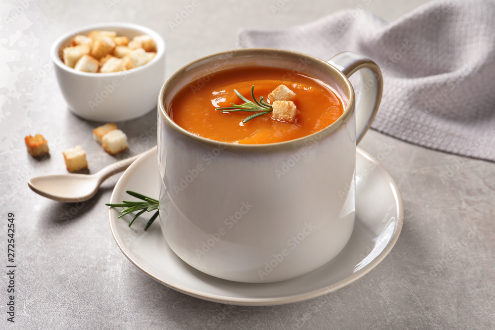 Mug of tasty sweet potato soup served on table Mug of tasty sweet potato soup served on table