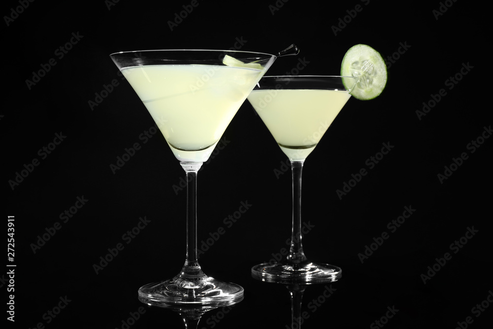 Glasses of delicious cucumber martini on dark background Glasses of delicious cucumber martini on dark background