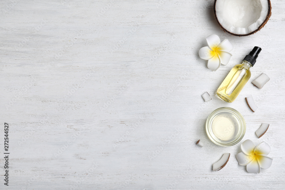 Flat lay composition with natural organic coconut oil on wooden background. Space for text
