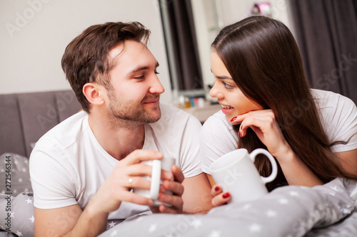 Happy couple having fun in bed. Intimate sensual young couple in bedroom enjoying each other