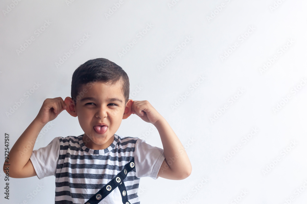 Six years boy portrait. Innocent smiling little boy on grey background. Little boy contorts his face. People, childhood lifestyle concept. Six years boy portrait. Innocent smiling little boy on grey background. Little boy contorts his face. People, childhood lifestyle concept.